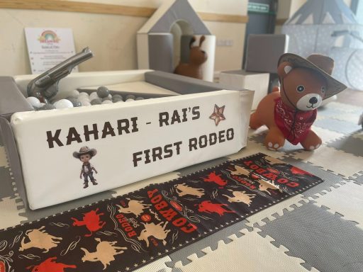 First Rodeo themed soft play setup with custom vinyl, western props, and accessories on hoppers.