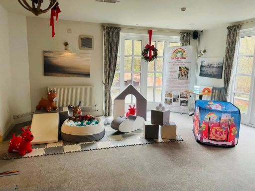 Christmas soft play setup with reindeer hoppers, red and green balls, Christmas tent, snowballs, and a visit from Elf.