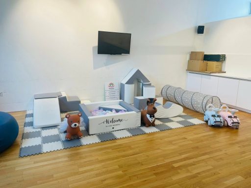 Grey and white soft play setup for a wedding, featuring vinyl personalisation and accessories on the hoppers.